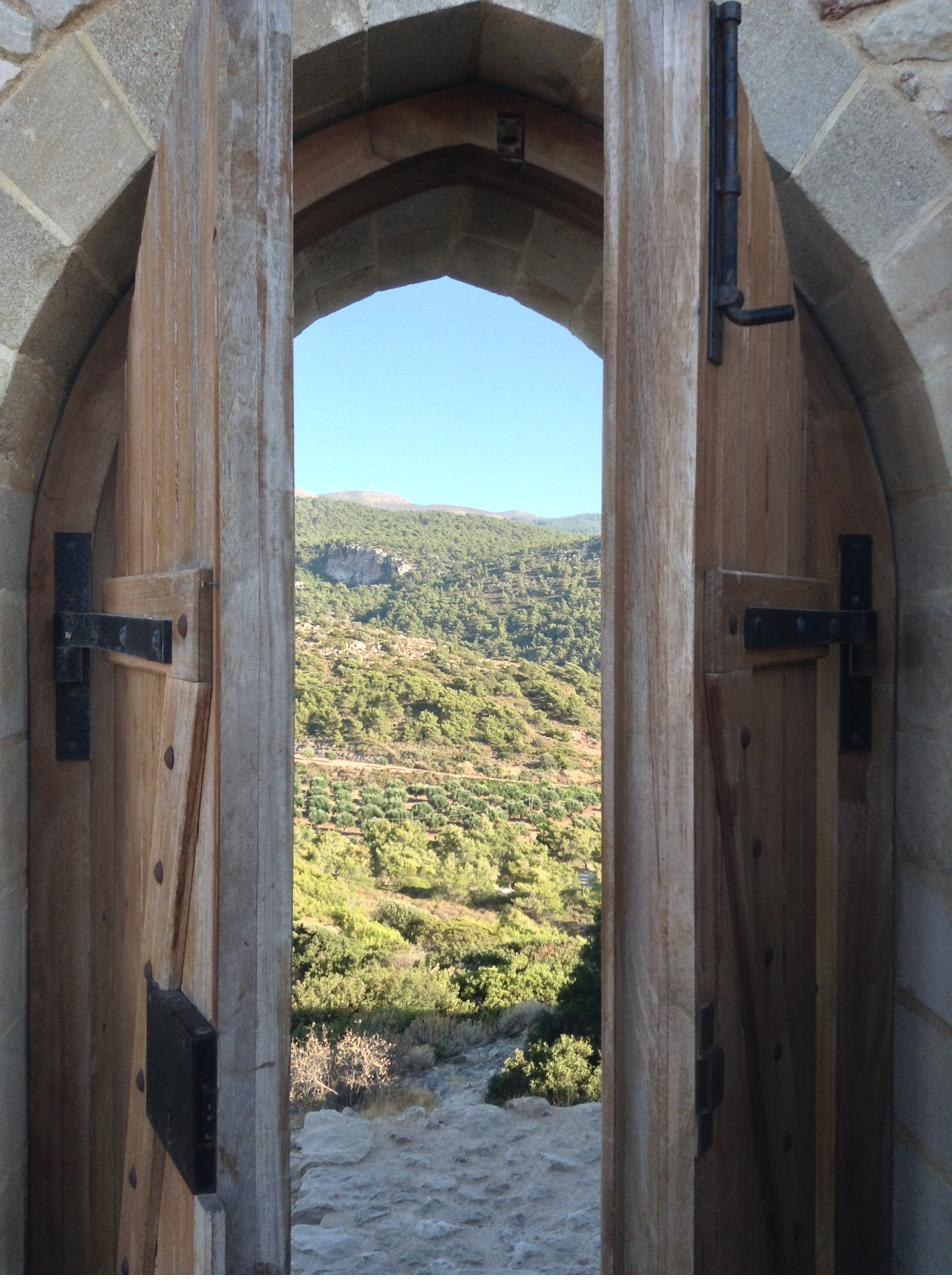 Old stone doorway opening onto a quiet courtyard