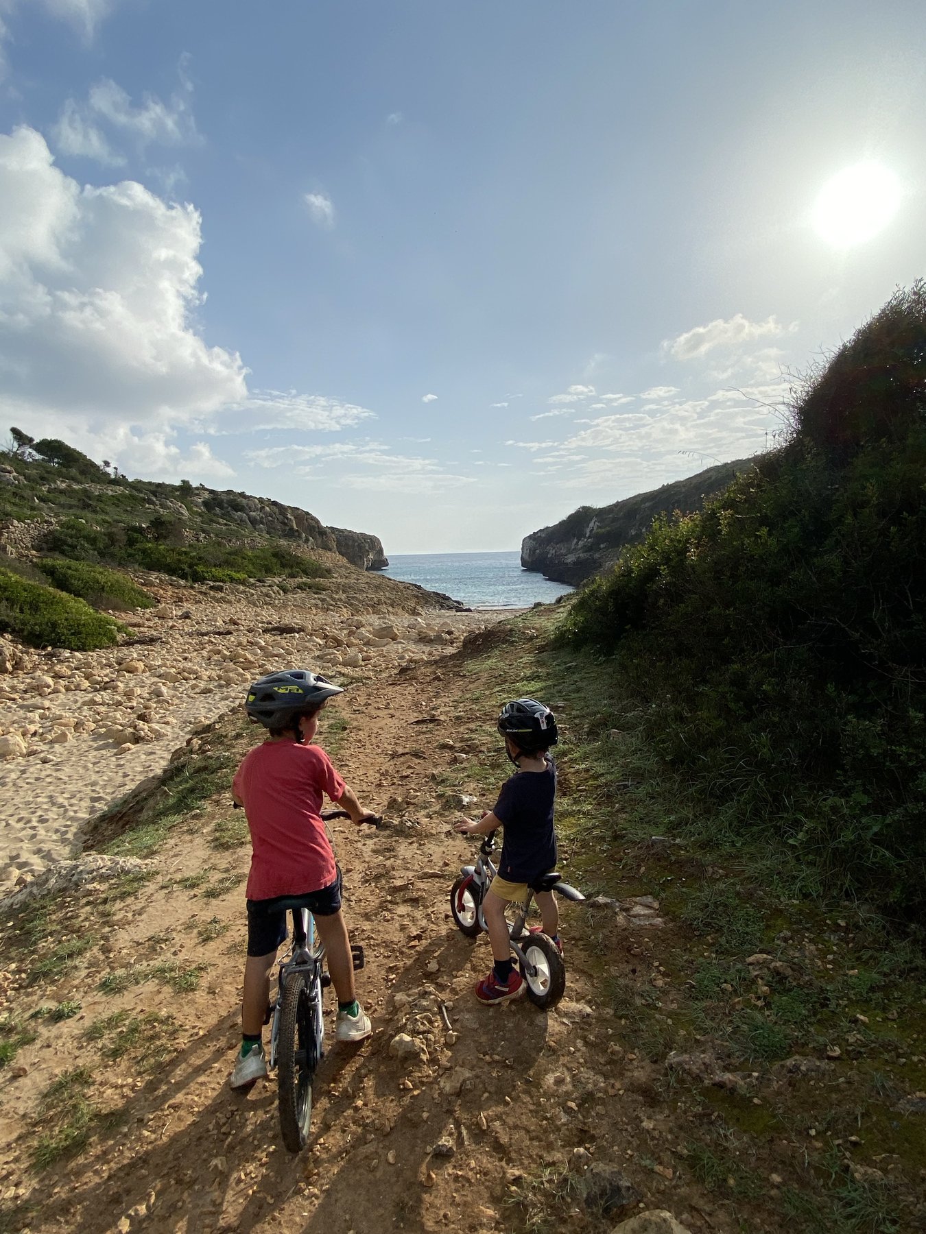 Two children on bikes heading to the cove