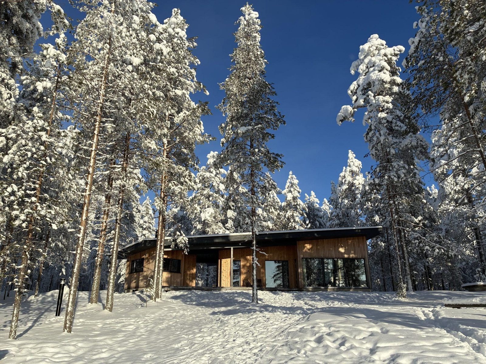 Wooden cabin under heavy snow, Lapland